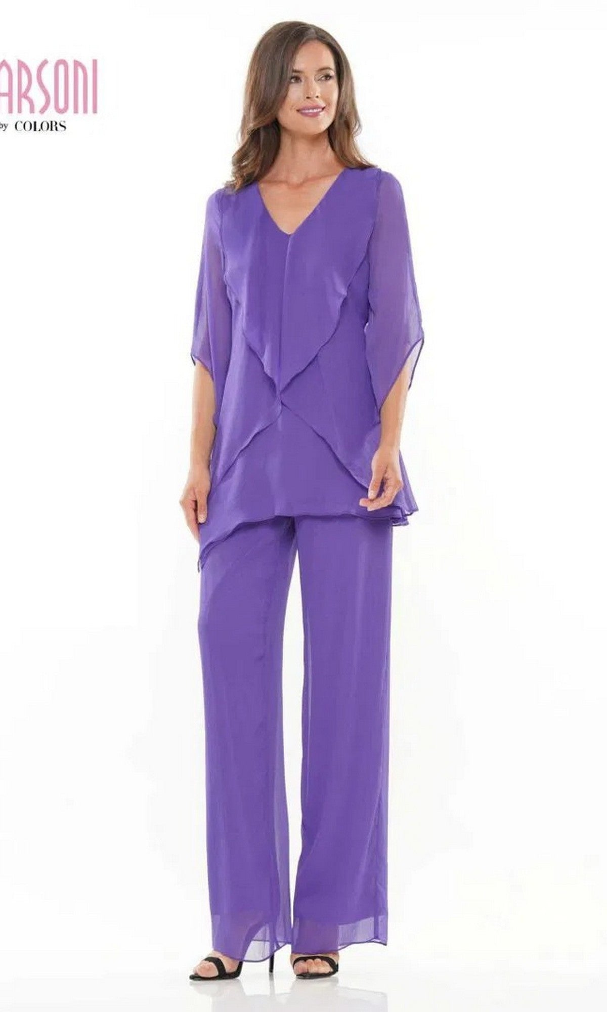 A woman models the Marsoni M308 Long Formal Pantsuit in Iris, featuring a loose fit with a layered top and wide-leg chiffon trousers, standing against a plain white background.